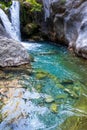 A beautiful mountain gorge with a river and a waterfall