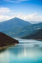 Beautiful mountain lake in Georgia, Zhinvali reservoir. Its turquoise colored water surrounded by Caucasus mountain ranges. Royalty Free Stock Photo