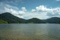 Beautiful mountain lake landscape, cloudy blue sky and green grass field, Malaysia Royalty Free Stock Photo