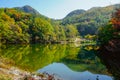 Beautiful mountain lake in the valley of the hills, in autumn, among thousands of colorful trees