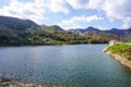 Beautiful mountain lake in the valley of the hills, in autumn, among thousands of colorful trees