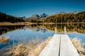 Beautiful mountain lake with a wooden pier near St. Moritz Royalty Free Stock Photo