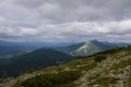 Forest and huge stones on top of the hillside near the peak of mountain range. Carpathians, Ukraine Royalty Free Stock Photo