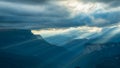 Beautiful mountain landscape. Black clouds over a mountain gorge. Slanting rays of the setting sun breaking through the Royalty Free Stock Photo