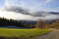 Beautiful mountain landscape covered with fog in autumn, path to the village,norwegian valley, Norway Buskerud Hemsedal