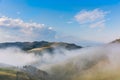 Beautiful mountain landscape of a foggy morning with trees and clouds Royalty Free Stock Photo