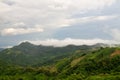 A beautiful mountain landscape with forest-covered peaks and cloudy skies Royalty Free Stock Photo