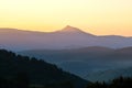 Beautiful mountain landscape with hazy peaks and foggy valley at sunset Royalty Free Stock Photo