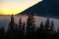 Beautiful mountain landscape with hazy peaks and foggy wooded valley at sunset Royalty Free Stock Photo