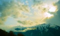 Beautiful mountain landscape: sky, clouds, sun and snow-capped mountains Royalty Free Stock Photo