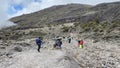 Beautiful mountain landscape. Tourists and porters go uphill. Climbing Kilimanjaro, Africa Royalty Free Stock Photo