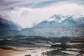 Beautiful mountain range under the clouds. Snowy peaks of rocks.