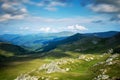 A beautiful mountain scenery. A dramatic, blue sky with many clouds. The heights of the mountains covered with green grass and Royalty Free Stock Photo