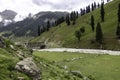 Beautiful mountain scenery. River, valley, snow, blue sky, white clouds. In-depth trip on the Sonamarg Hill Trek in Jammu and Royalty Free Stock Photo