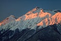 Beautiful mountain scenic winter landscape of the Main Caucasian ridge with snowy peaks on blue sky background at sunset Royalty Free Stock Photo