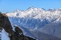 Beautiful mountain scenic winter landscape of Main Caucasus Mountains ridge with snowy Chugush mountain peak and blue sky on sunny Royalty Free Stock Photo