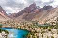 The beautiful mountain trekking road with clear blue sky and rocky hills and the view of Alaudin lake in Fann mountains in