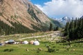 Beautiful mountain valley with Kyrgyz traditional yurts near Barskoon waterfall - splashes of champagne. Travel, tourism concept. Royalty Free Stock Photo