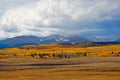 Beautiful mountainous landscape with autumn colors under a breathtaking cloudy sky Royalty Free Stock Photo