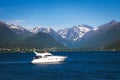 Beautiful mountains and fjord in Norway with a white pleasure boat Royalty Free Stock Photo