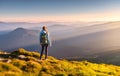 Beautiful mountains in fog and standing young woman with backpack