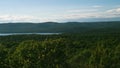 Beautiful mountains with foliate forest and green trees at sunset