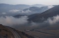 Beautiful mountains landscape, huge fluffy clouds descended to the mountain tops.