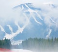 Beautiful mountains landscape, nature, forests in a white haze, fog, ski slopes, ski resort Bukovel in the winter Royalty Free Stock Photo