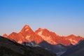 Beautiful mountains at sunset, small traveler in big landscape