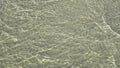 Beautiful moving water surface at a baltic sea beach with sunlight caustics