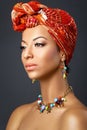 Beautiful mulatto young woman with turban on head Royalty Free Stock Photo