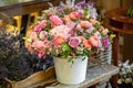 Beautiful multi-colored bouquet of mixed roses and other flowers in a shop. Fresh cut flowers placed in white flower pot Royalty Free Stock Photo