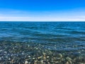 Beautiful multi-colored round stones on the sea, rivers, lakes, pond, ocean and boiling water with waves on the rocky beach Royalty Free Stock Photo