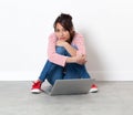 Beautiful multi-ethnic young woman sitting on the floor daydreaming Royalty Free Stock Photo