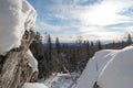 Beautiful multi-tiered small rock covered with snow in the forest. Winter walks in the forest. Hiking in winter