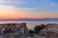 Beautiful multicolor sunset on Lake Garda. View from the scenic ruins of Grottoes of Catullus, roman villa in Sirmione city, Italy