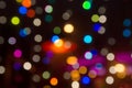 Beautiful multicolored bokeh lights holiday glitter background for Christmas New Years Eve celebration with golden garland Royalty Free Stock Photo