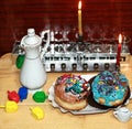 Beautiful multicolored Hanukkah donuts. Pastry decoration on donuts. Chanukia, Sevivon, Dreidl. Royalty Free Stock Photo