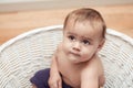 Beautiful multicultural baby in white basket Royalty Free Stock Photo