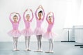 beautiful multiethnic kids in pink tutu skirts practicing