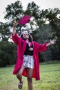 Beautiful multiethnic woman celebrating in her graduation cap and gown