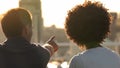 Beautiful multiracial couple looking at city from the roof at sunny day, date Royalty Free Stock Photo