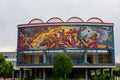 Beautiful mural on building from Mexican college under cloudy sky