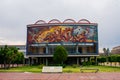 Beautiful mural on building from Mexican college under cloudy sky