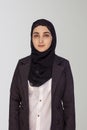 Beautiful Muslim businesswoman in hijab against white background. Portrait of pretty middle-eastern female wearing traditional Royalty Free Stock Photo