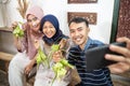 muslim family and friend making ketupat for eid fitr mubarak