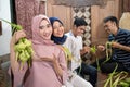 muslim family and friend making ketupat for eid fitr mubarak