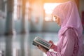 Beautiful Muslim girl reading book with hijab and smiling Royalty Free Stock Photo