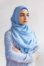 Beautiful Muslim woman in hijab against white background. Portrait of pretty middle-eastern female wearing traditional Islamic Royalty Free Stock Photo