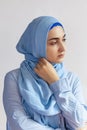 Beautiful Muslim woman in hijab against white background. Portrait of pretty middle-eastern female wearing traditional Islamic Royalty Free Stock Photo